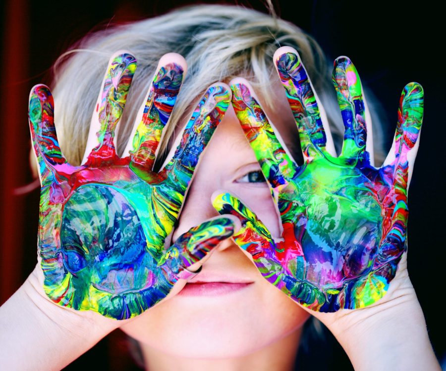 pexels-photo-1148998-1148998 Vibrant close-up of a child's hands covered in colorful paint, expressing creativity and fun.